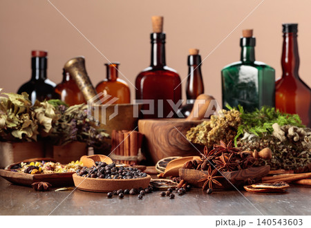 Rustic still life with vintage bottles, medicinal herbs, juniper berries and fragrant spices. Rustic still life with vintage bottles, medicinal herbs, juniper berries and fragrant spices. 140543603