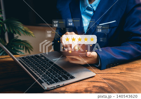 Customer reviews concept. Business Person Analyzing Customer Feedback and Ratings on Laptop for Improved Service and Product Quality 140543620