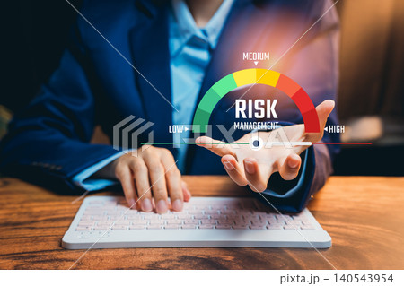 Risk management concept. Businessman analyzing low to high risk gauge on digital dashboard for corporate strategy, financial security, and business decision planning Risk management concept. Businessman analyzing low to high risk gauge on digital dashboard for corporate strategy, financial security, and business decision planning 140543954