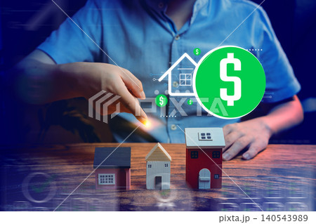 real estate investment, hand pointing at house models with dollar icon, property finance and wealth growth concept 140543989