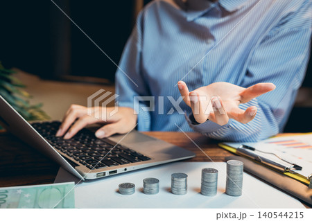 Business concept. Business Person Analyzing Data While Discussing Financial Growth and Investment Strategies at Workspace 140544215