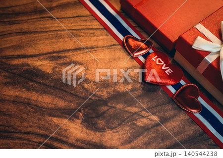 Love concept. Romantic Gifts and Symbols of Love on a Wooden Surface with Red and White Theme Love concept. Romantic Gifts and Symbols of Love on a Wooden Surface with Red and White Theme 140544238