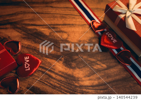 Love concept. Romantic Red Hearts and Gift Boxes on a Wooden Table for Valentine's Day Celebration Love concept. Romantic Red Hearts and Gift Boxes on a Wooden Table for Valentine's Day Celebration 140544239