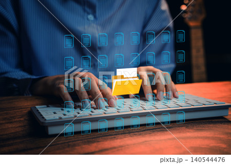 File management. Digital document management, person typing on keyboard with virtual file folder interface, cloud storage workflow and business data organization File management. Digital document management, person typing on keyboard with virtual file folder interface, cloud storage workflow and business data organization 140544476