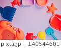Summer flat lay. Colorful Plastic Beach Toys and Accessories for Summer Fun with Crabs, Starfish, and Sandcastle Tools 140544601