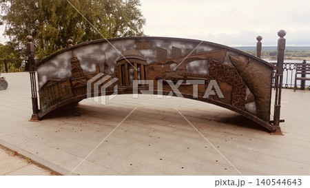 Large Curved Metal Relief Sculpture Depicting City Landmarks and Bear on River Embankment Large Curved Metal Relief Sculpture Depicting City Landmarks and Bear on River Embankment 140544643