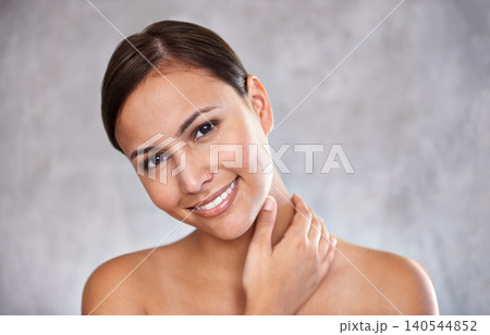 Portrait, natural beauty and woman with smile for cosmetic care, shine and hand touching skin on grey background. Dermatology, wellness and hygiene, moisturizing body for glow and clean skincare Portrait, natural beauty and woman with smile for cosmetic care, shine and hand touching skin on grey background. Dermatology, wellness and hygiene, moisturizing body for glow and clean skincare 140544852