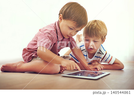 Siblings, children and tablet on a floor with cartoon, gaming or streaming movie at home. Digital, learning and boy kids in house for google it, search or ebook storytelling, app or netflix and chill Siblings, children and tablet on a floor with cartoon, gaming or streaming movie at home. Digital, learning and boy kids in house for google it, search or ebook storytelling, app or netflix and chill 140544861