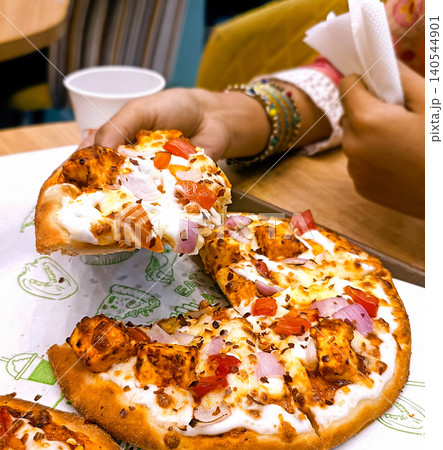 Delicious Freshly Baked Paneer Pizza with Vegetable Toppings 140544901