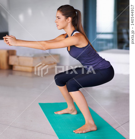 Gym, squats and woman with yoga mat for workout, training and fitness indoor at home, house and patio. Active wear, strong and athlete using equipment for wellness, health and focus on exercise Gym, squats and woman with yoga mat for workout, training and fitness indoor at home, house and patio. Active wear, strong and athlete using equipment for wellness, health and focus on exercise 140544917