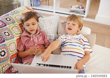 Whats that. Laptop, kids and siblings on sofa for cartoon, film or streaming movie at home. Computer, learning or boy children in house for search or hand pointing to video show. Whats that. Laptop, kids and siblings on sofa for cartoon, film or streaming movie at home. Computer, learning or boy children in house for search or hand pointing to video show. 140544983