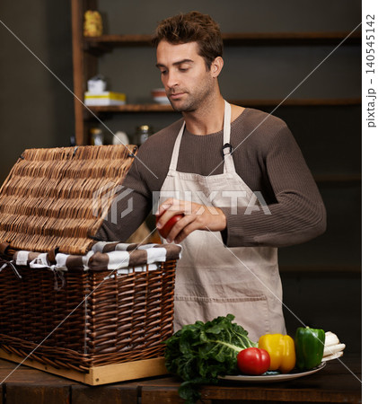 Man, basket and business owner with vegetables or groceries in a bag for cooking or diet in kitchen. Chef packing, shopkeeper and person sorting healthy food dinner or packaging box of ingredients 140545142