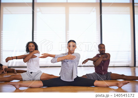 Dancer, class and people stretching legs on floor to start rehearsal together in studio or academy. Training, body and healthy exercise for fitness in creative school with yoga or pilates workout Dancer, class and people stretching legs on floor to start rehearsal together in studio or academy. Training, body and healthy exercise for fitness in creative school with yoga or pilates workout 140545172
