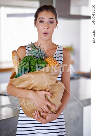 Home, shock or portrait of woman with groceries on promotion, sale or discounts deal on nutrition. Wow, delivery offer surprise or person buying healthy food for cooking organic fruits or diet choice Home, shock or portrait of woman with groceries on promotion, sale or discounts deal on nutrition. Wow, delivery offer surprise or person buying healthy food for cooking organic fruits or diet choice 140545210