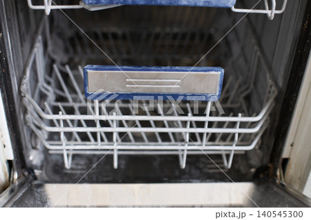 Empty dishwasher interior showing limescale and grime Empty dishwasher interior showing limescale and grime 140545300