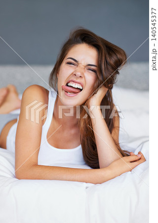 Relax, silly and portrait of woman in bed, lazy and sleeping on soft mattress in bedroom of home. Wellness, health and female person comic in hotel room with cozy blanket or duvet, pillow and sheets Relax, silly and portrait of woman in bed, lazy and sleeping on soft mattress in bedroom of home. Wellness, health and female person comic in hotel room with cozy blanket or duvet, pillow and sheets 140545377