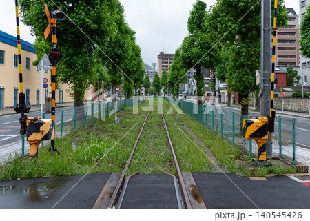 Railway track with green trees in a Japanese city Railway track with green trees in a Japanese city 140545426