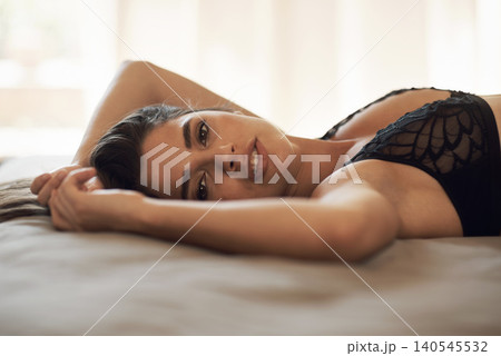 Portrait, lingerie and woman on bed for fashion, confidence or sexy clothing at modern apartment Attractive, rest and beautiful young female person from Colombia in underwear in bedroom at home. 140545532