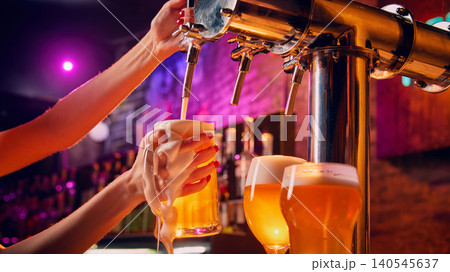 Female bartender filling beer mug with foam near pub tap. Female bartender filling beer mug with foam near pub tap. 140545637