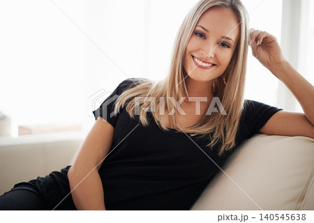 Happy, portrait and woman on a sofa relax with confidence, positive attitude or leisure in her home. Face, smile and female person in a living room with vacation, free time or resting holiday Happy, portrait and woman on a sofa relax with confidence, positive attitude or leisure in her home. Face, smile and female person in a living room with vacation, free time or resting holiday 140545638