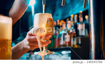 Female hand holding draft beer glass with foam spilling over rim. Female hand holding draft beer glass with foam spilling over rim. 140545700