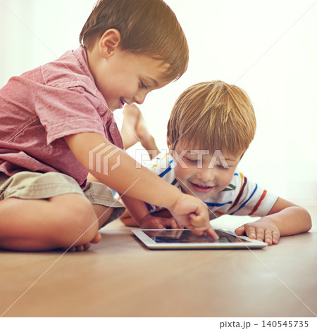 Children, siblings and tablet on a floor with cartoon, gaming or streaming movie at home. Digital, learning and boy kids in house for search or ebook storytelling, app and chill Children, siblings and tablet on a floor with cartoon, gaming or streaming movie at home. Digital, learning and boy kids in house for search or ebook storytelling, app and chill 140545735
