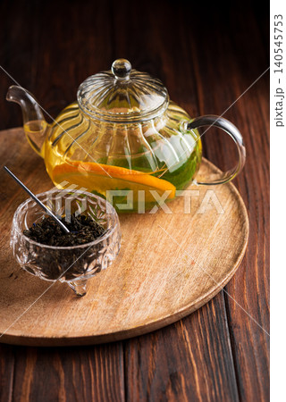 Herbal tea brewing with orange and mint leaves Herbal tea brewing with orange and mint leaves 140545753