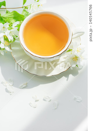 Jasmine tea in elegant teacup with white flowers Jasmine tea in elegant teacup with white flowers 140545766