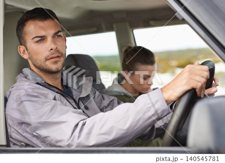 Couple, car and driving on roadtrip with travel for adventure, vacation and concentration of driver in countryside. Woman, man and serious in transport for holiday journey, tourism and honeymoon trip 140545781