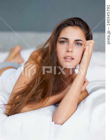Confident, relax and portrait of woman in bed with wellness, morning and natural in apartment. Face, home and girl in bedroom with peace, calm and wake up for healthy sleep, comfort and weekend rest Confident, relax and portrait of woman in bed with wellness, morning and natural in apartment. Face, home and girl in bedroom with peace, calm and wake up for healthy sleep, comfort and weekend rest 140545791