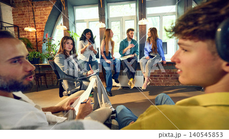 Creative office team having casual group discussion in loft workspace Creative office team having casual group discussion in loft workspace 140545853