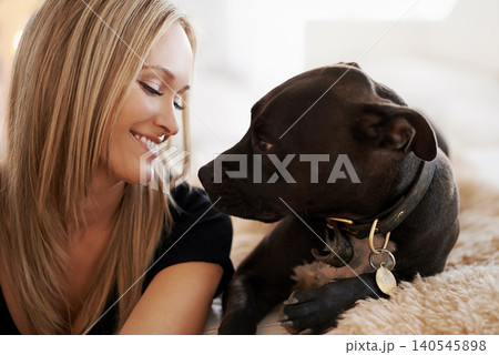 Smile, love or woman and dog on a sofa with trust, care and bonding at home together. Pets, face and female person relax with pitbull puppy in a living room with security, protection or foster safety Smile, love or woman and dog on a sofa with trust, care and bonding at home together. Pets, face and female person relax with pitbull puppy in a living room with security, protection or foster safety 140545898