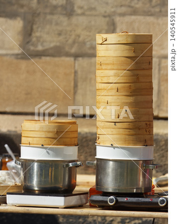 Traditional stacked bamboo steamers at Asian street food market in Karlin Traditional stacked bamboo steamers at Asian street food market in Karlin 140545911
