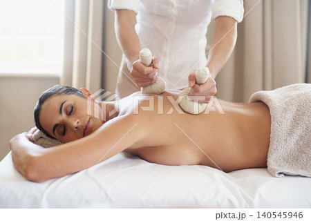 Relax, herbal compress and massage of woman at spa for skincare, peace or calm at luxury resort. Beauty, therapy and masseuse with bag at salon for body treatment, health and hands of person on back 140545946