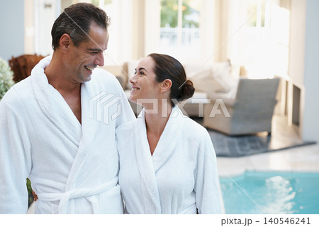 Holiday, robe and couple at hotel pool with smile, embrace and relax together at wellness spa getaway. Hospitality, happy woman and man at luxury villa for travel, vacation and love on romantic date Holiday, robe and couple at hotel pool with smile, embrace and relax together at wellness spa getaway. Hospitality, happy woman and man at luxury villa for travel, vacation and love on romantic date 140546241