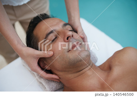 Outdoor, spa and man relax for facial massage on table in hotel, calm and care for body in vacation. Holiday, luxury and male person on break for weekend, resort and lodge with treatment for skincare Outdoor, spa and man relax for facial massage on table in hotel, calm and care for body in vacation. Holiday, luxury and male person on break for weekend, resort and lodge with treatment for skincare 140546500