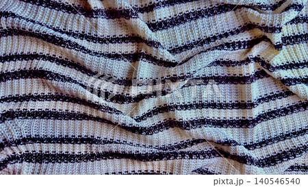 rumpled luxurious cream black striped knitted blanket drapes softly in cozy textured waves 140546540