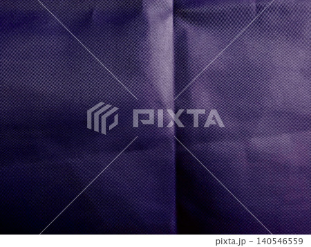 deep purple denim fabric closeup highlights intricate weave and natural wrinkles in textured folds deep purple denim fabric closeup highlights intricate weave and natural wrinkles in textured folds 140546559
