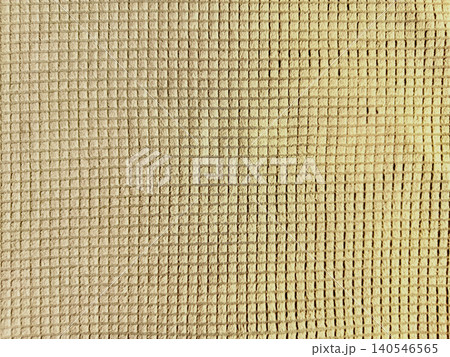 beige mesh fabric grid texture close up reveals uniform square pattern in serene natural weave detail 140546565