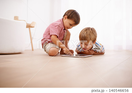 Tablet, kids and siblings on a floor with cartoon, gaming or streaming movie at home. Digital, learning and boy children in house for google it, search or ebook storytelling, app or Netflix and chill 140546656