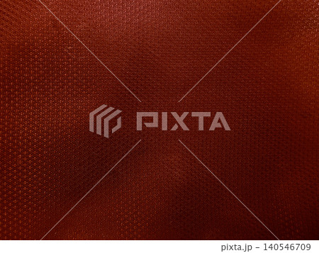textured rust brown synthetic athletic fabric background close up view showcasing macro woven mesh grid pattern 140546709