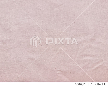 wrinkled pale pink organic cotton fabric texture background showing sustainable textile details in a minimalist flat lay 140546711