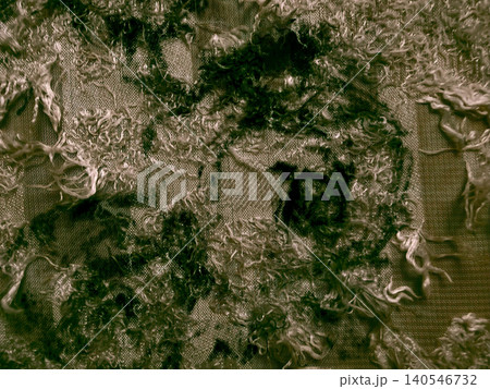 deconstructed textured fabric with messy fringed threads creates a dark mossy abstract background 140546732
