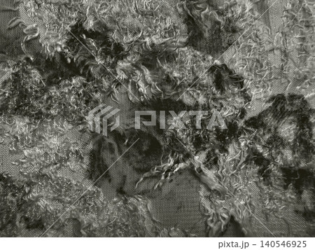 raw unspun wool roving creates abstract texture on sheer organic fabric in monochromatic minimalist flat lay raw unspun wool roving creates abstract texture on sheer organic fabric in monochromatic minimalist flat lay 140546925