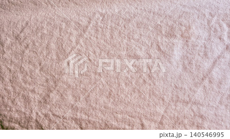 dusty rose wrinkled linen fabric texture displaying raw organic sustainable textile weave 140546995