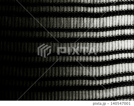 monochromatic striped textile fabric macro reveals tactile knit weave textures under dramatic side lighting 140547001
