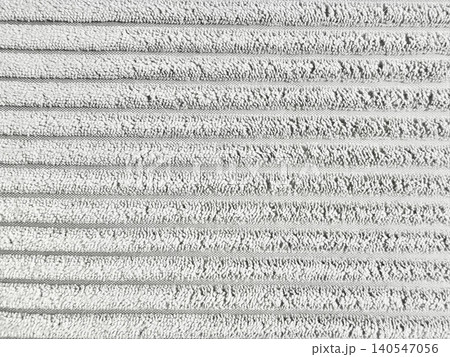 white corduroy fabric texture showcases detailed ribbed wales creating a minimalist abstract background pattern 140547056