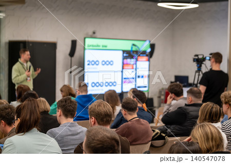 Business conference presentation with speaker, audience and camera recording in modern meeting space Business conference presentation with speaker, audience and camera recording in modern meeting space 140547078