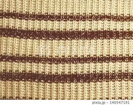 luxurious cream knit fabric with bold brown horizontal stripes reveals intricate textured stitch in cozy closeup luxurious cream knit fabric with bold brown horizontal stripes reveals intricate textured stitch in cozy closeup 140547191