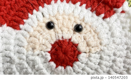 crocheted santa claus face glows festively with red yarn hat fluffy white beard black button eyes and textured red nose crocheted santa claus face glows festively with red yarn hat fluffy white beard black button eyes and textured red nose 140547203
